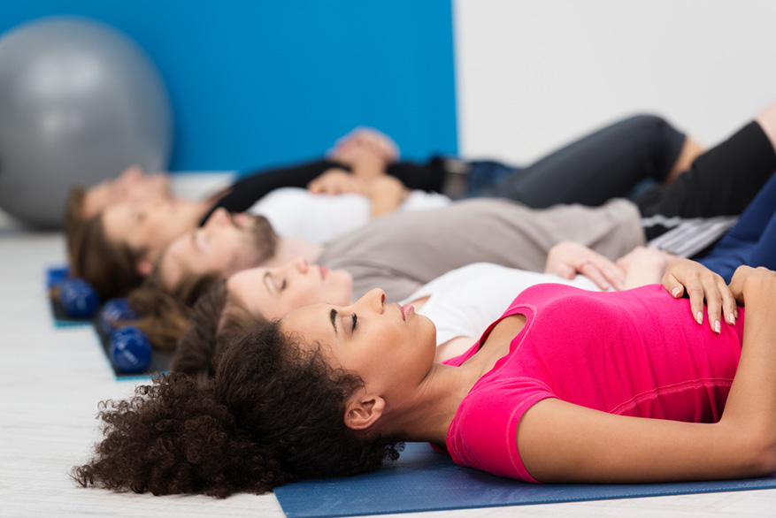 aerobics class practicing deep breathing