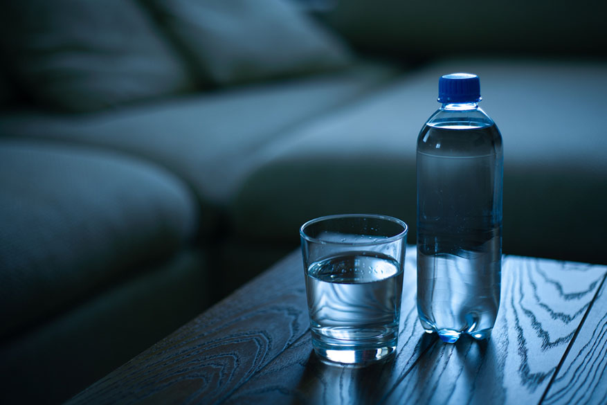 bottle and glass at night