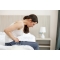 lady sitting on bed in pain