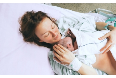 mother holding newborn after birth