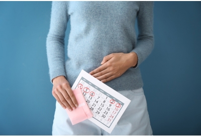 woman with menstrual pad and calendar