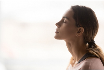 woman taking a deep breath