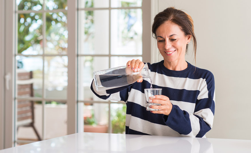 woman pouring a glass of water