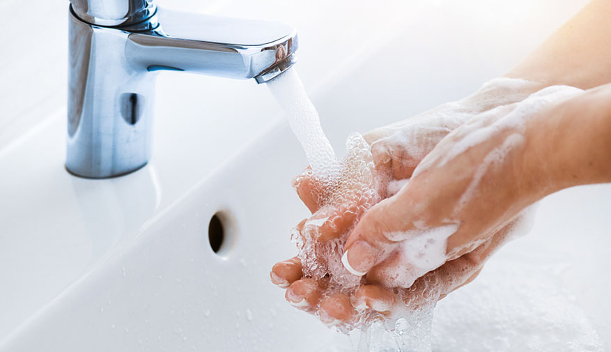 washing hands at sink with soap