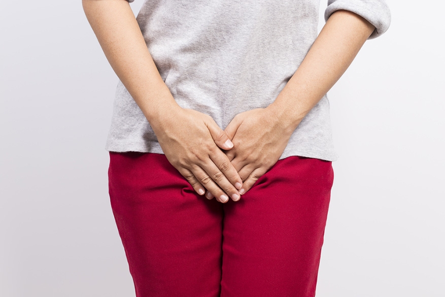 woman with hands holding her crotch