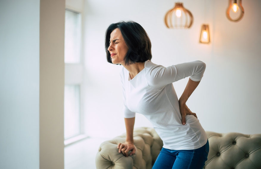 woman holding lower back in pain