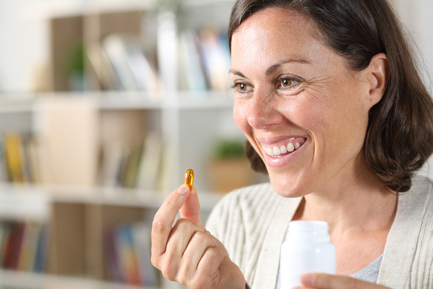 woman holding vitamin