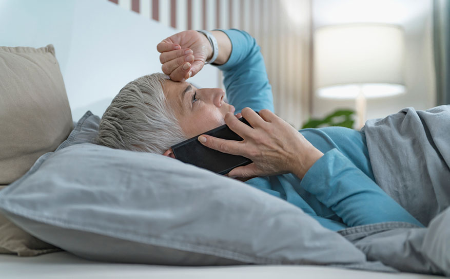 woman in bed on phone