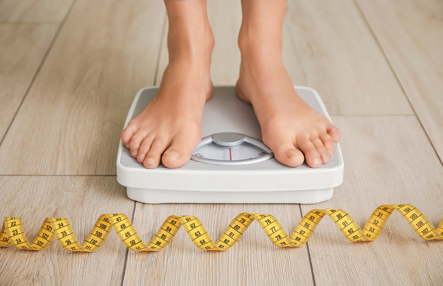 woman measuring her weight