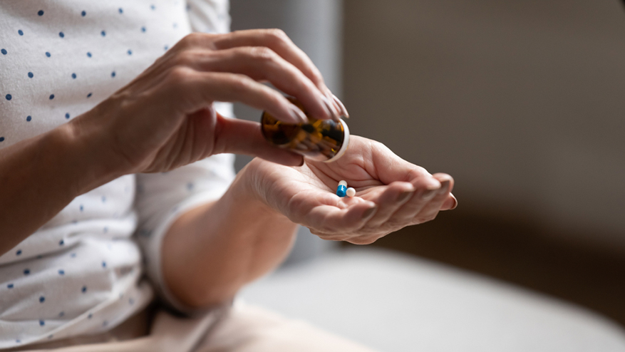 woman pours out pills