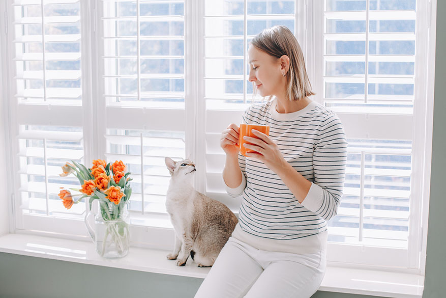 woman sitting with coffee mug in hand